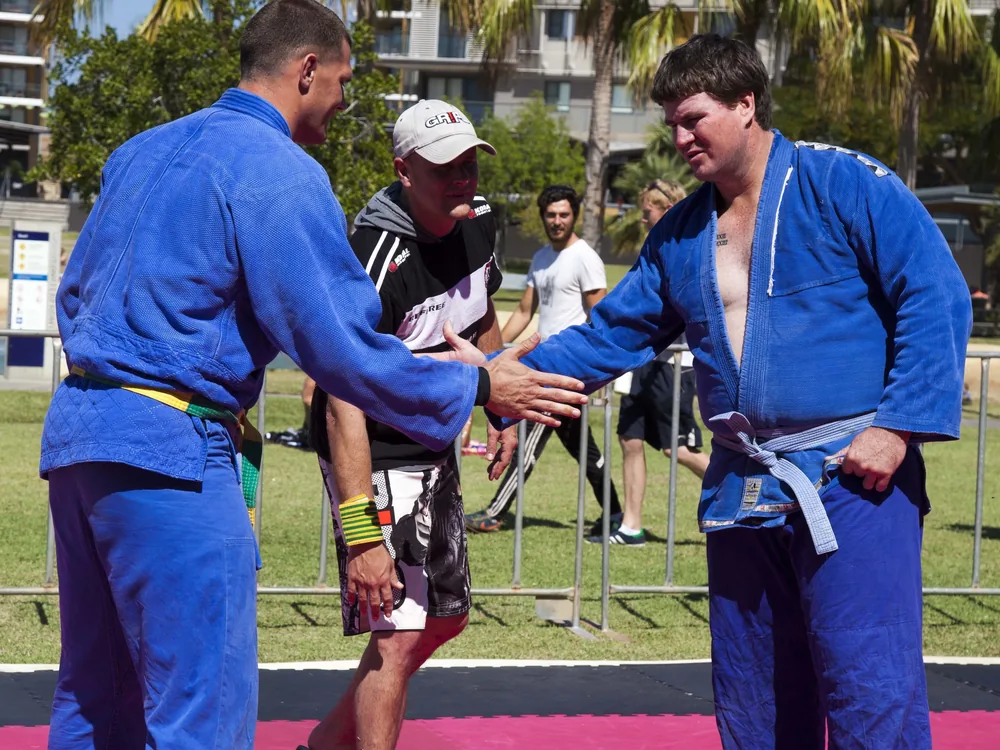 Two grapplers competing on the mat in a Brazilian jiu-jitsu match